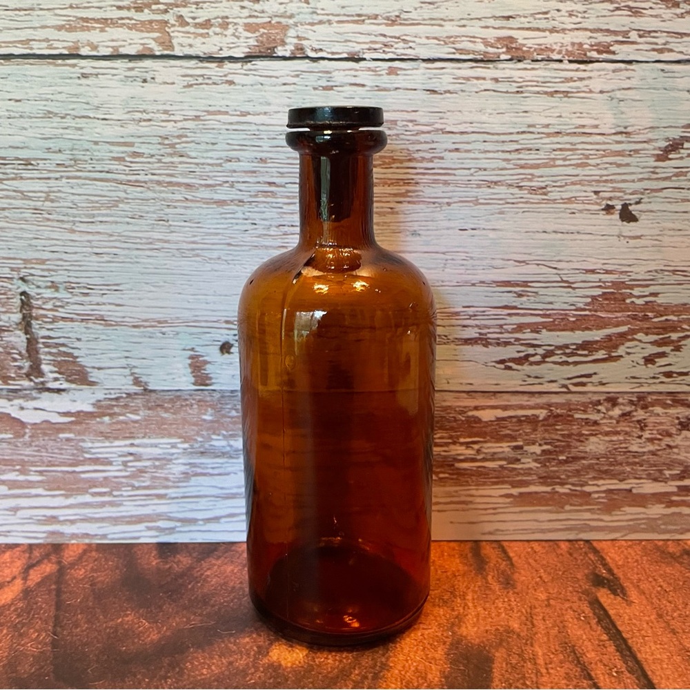 Antique brown bottle with glass stopper lid